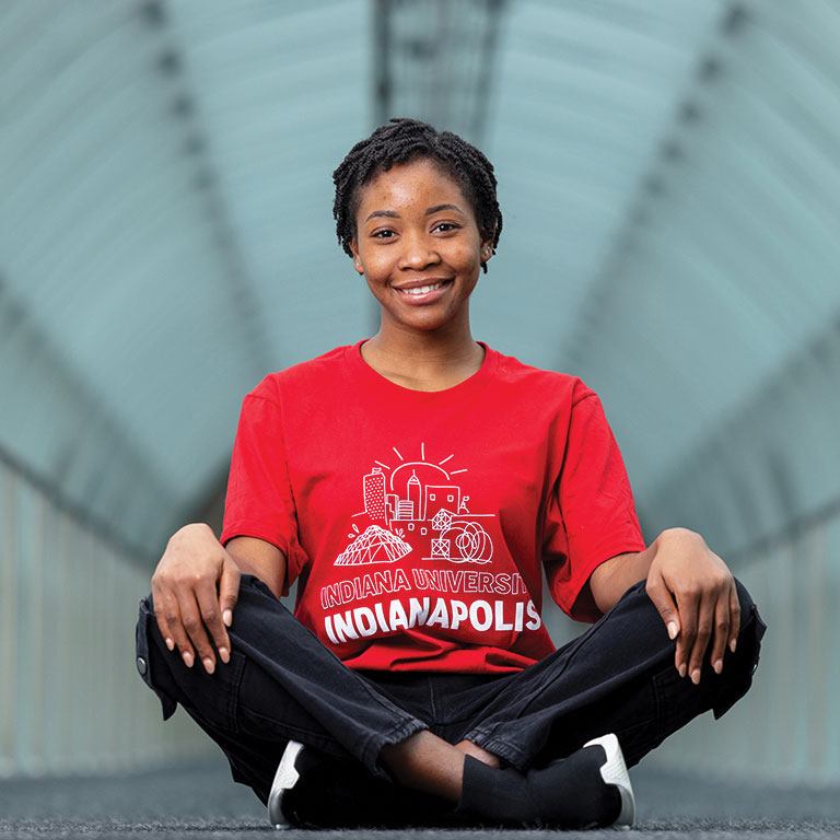 Image of Faith Odiete sitting with an IU Indianapolis shirt.
