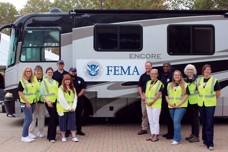 Group photo in front of FEMA trailer